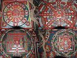 Mustang Lo Manthang 04 04-3 Jampa Gompa Mandalas The third story of Jampa Lhakhang is painted with a single row of 28 mandalas, all of them tantric, with couples in yab-yum in the centre of each. Between the mandalas are smaller vignettes depicting yi-dams, singly and in yab-yum, and minor beings.